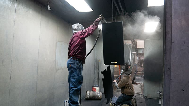 Lawrence Brothers employees preparing the powder coating on a manufacturing project